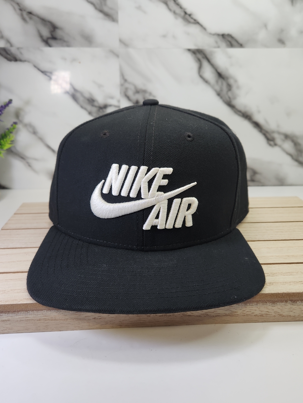 Nike Air Cap. Black Snapback Hat with White Embroidered Nike Air Logo.